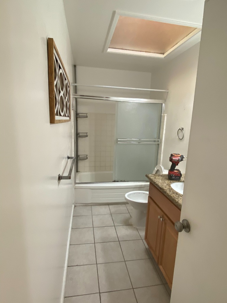 Bathroom Remodel — Before: Original tile, oak vanity, outdated fixtures