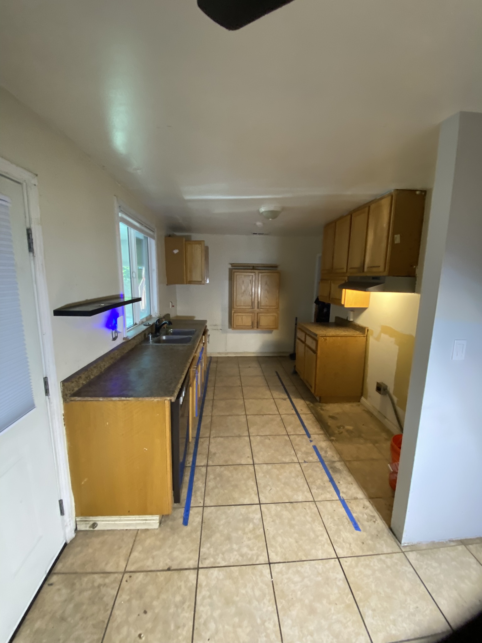 Kitchen Remodel — Before: Original oak cabinets, old floor tile, dated layout